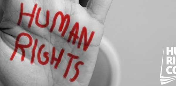 A hand held up with the words 'Human Rights' painted on it.