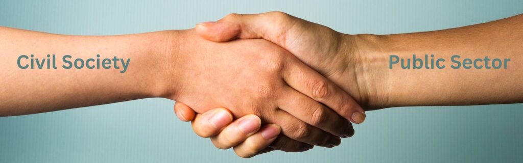 Two hands are shaking. One has the words 'Civil Society' while the other has the words 'Public Sector'.